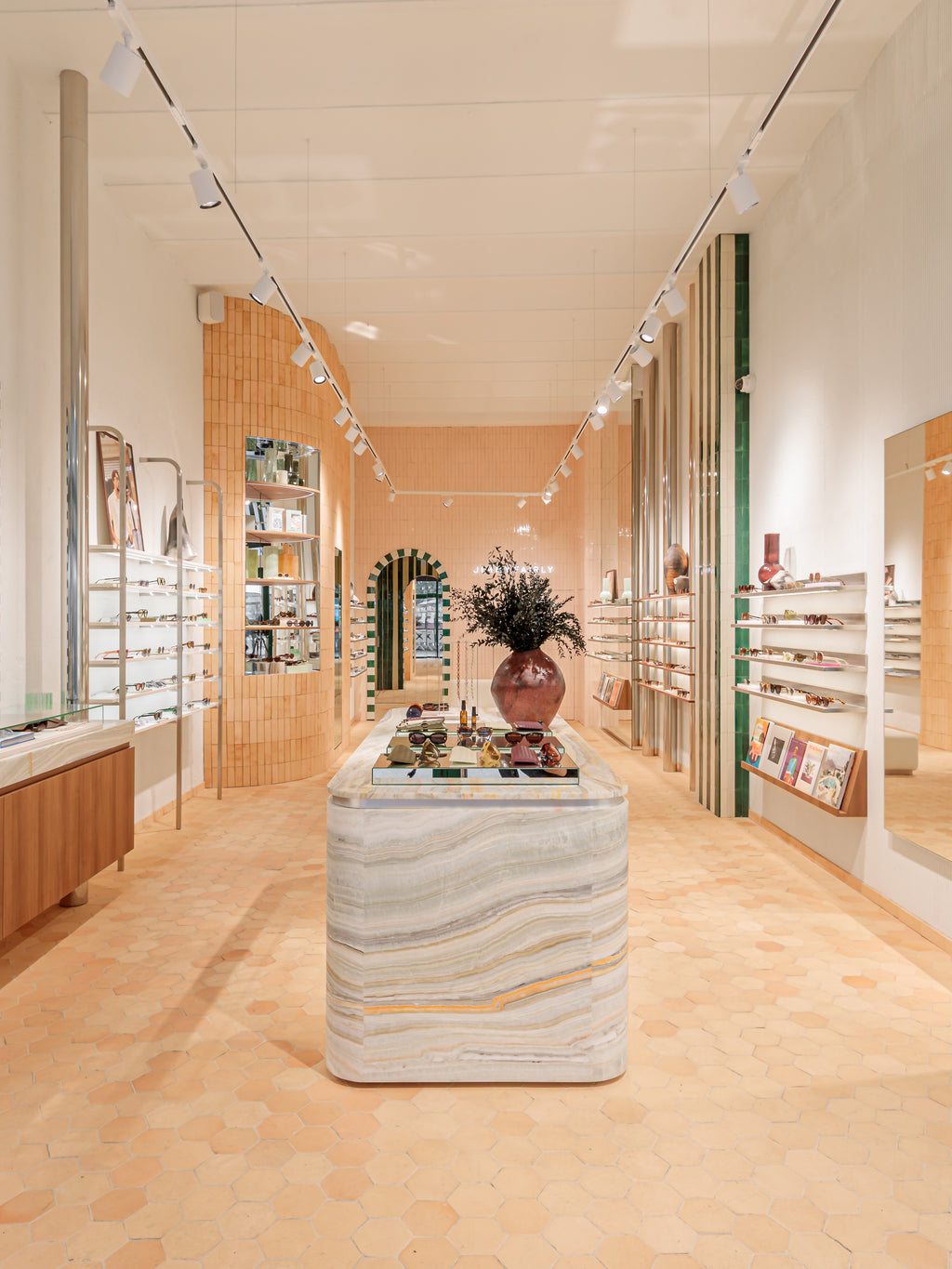 Modern interior design of a store with marble counter and shelves.