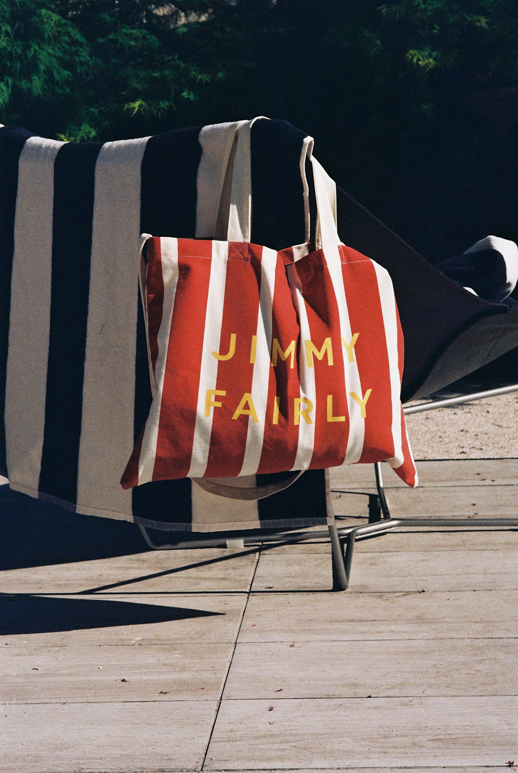 red tote bag hanging on a chair